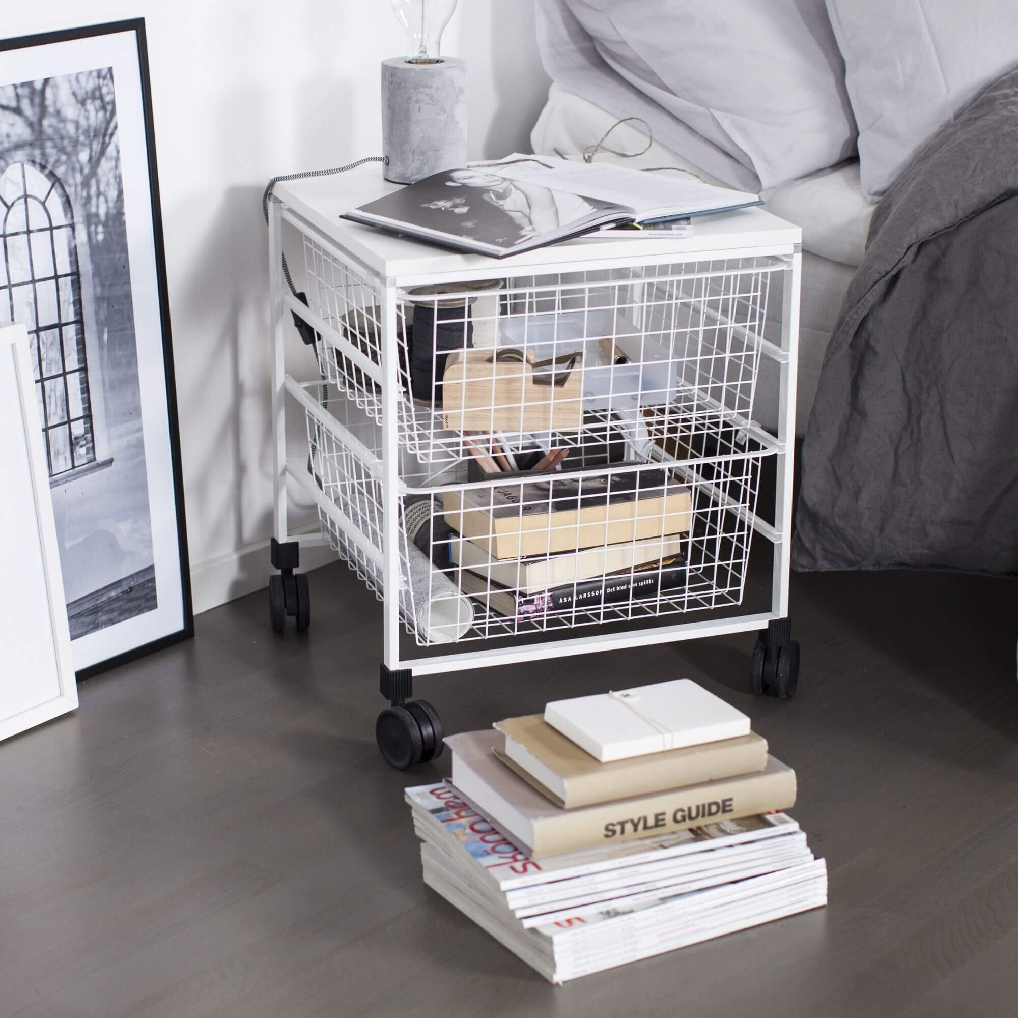 A white Elfa Freestanding Drawer Unit used in a bedroom to store books and accessories