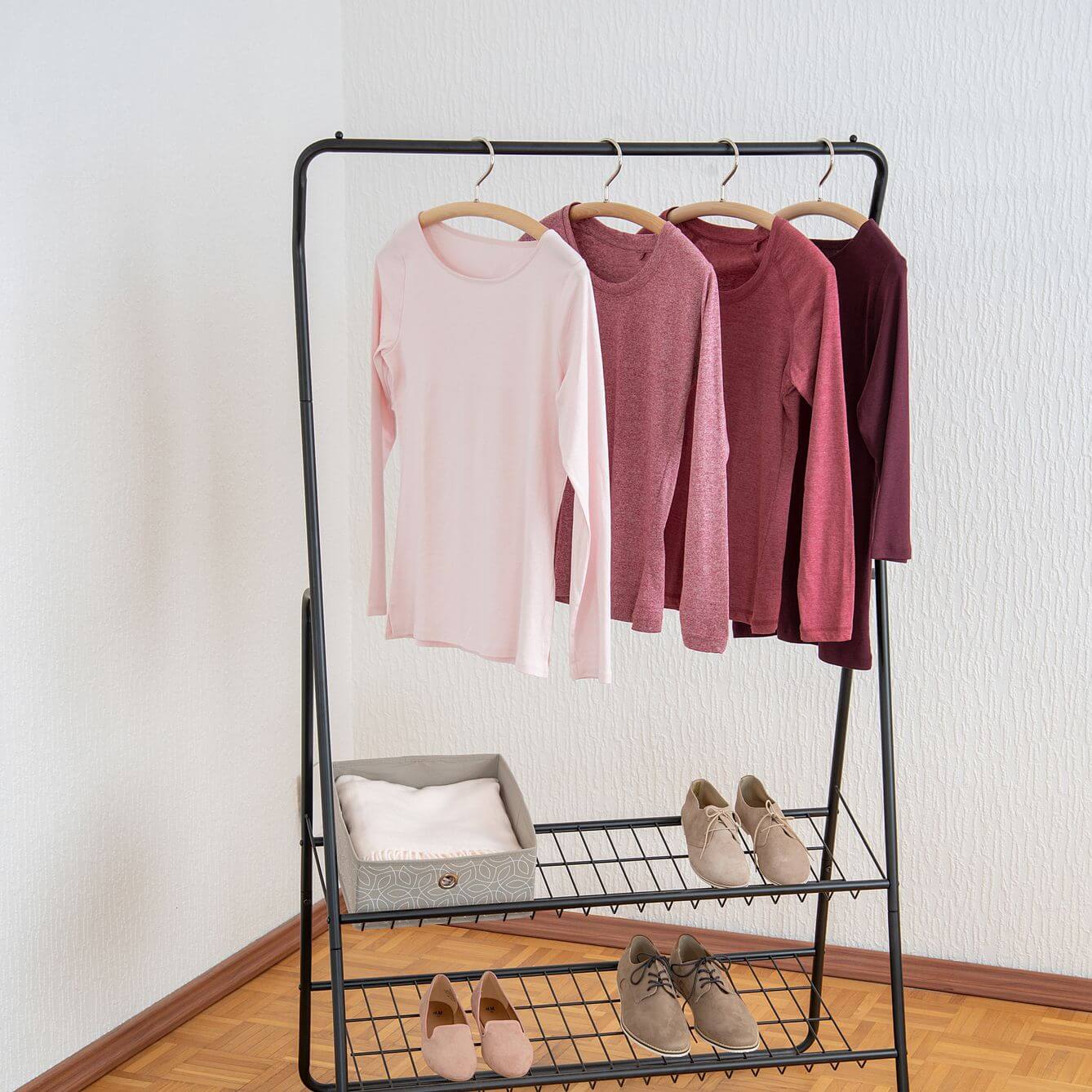 Clothes hanging on a matte black clothes rack