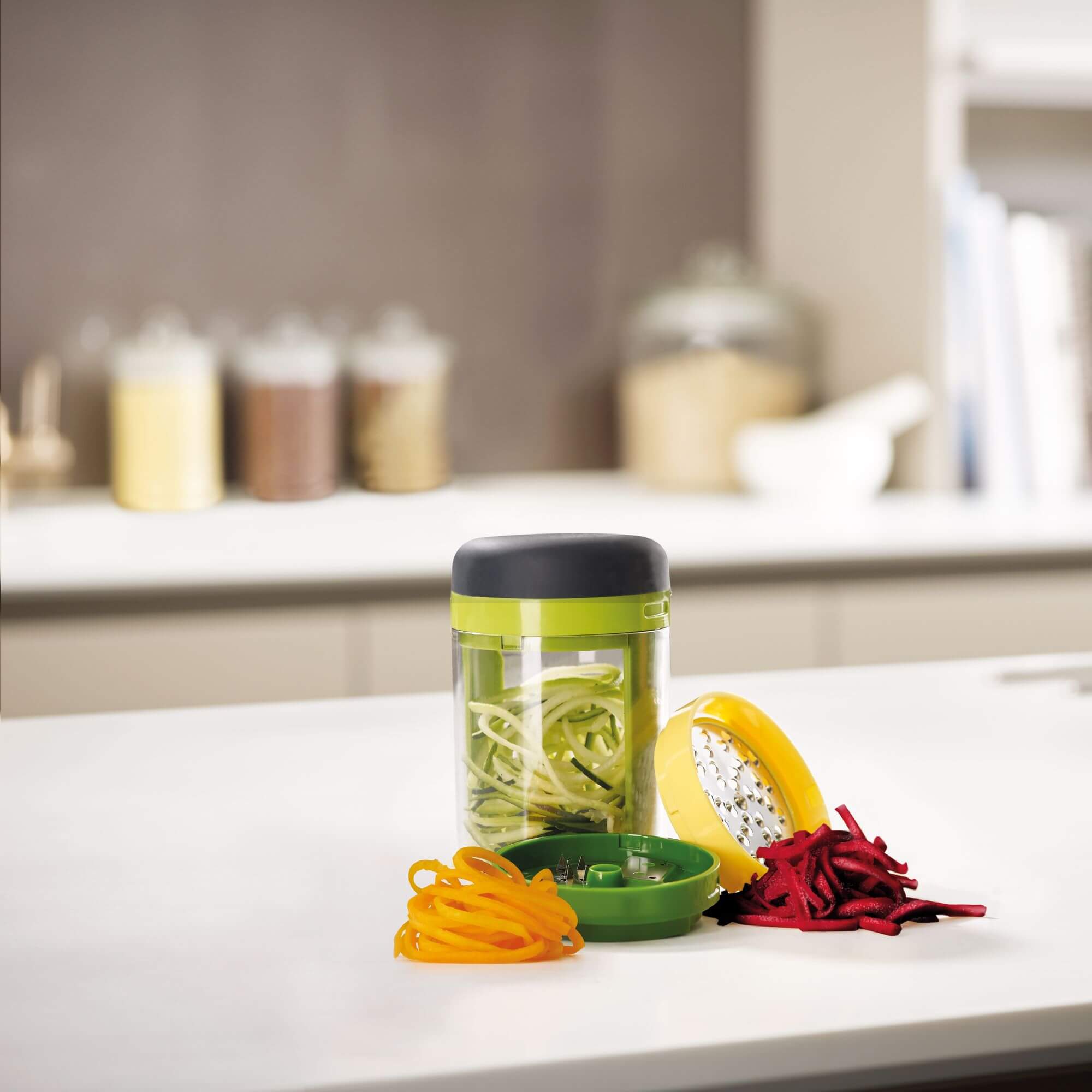 A Joseph Joseph vegetable spiralizer on a kitchen bench