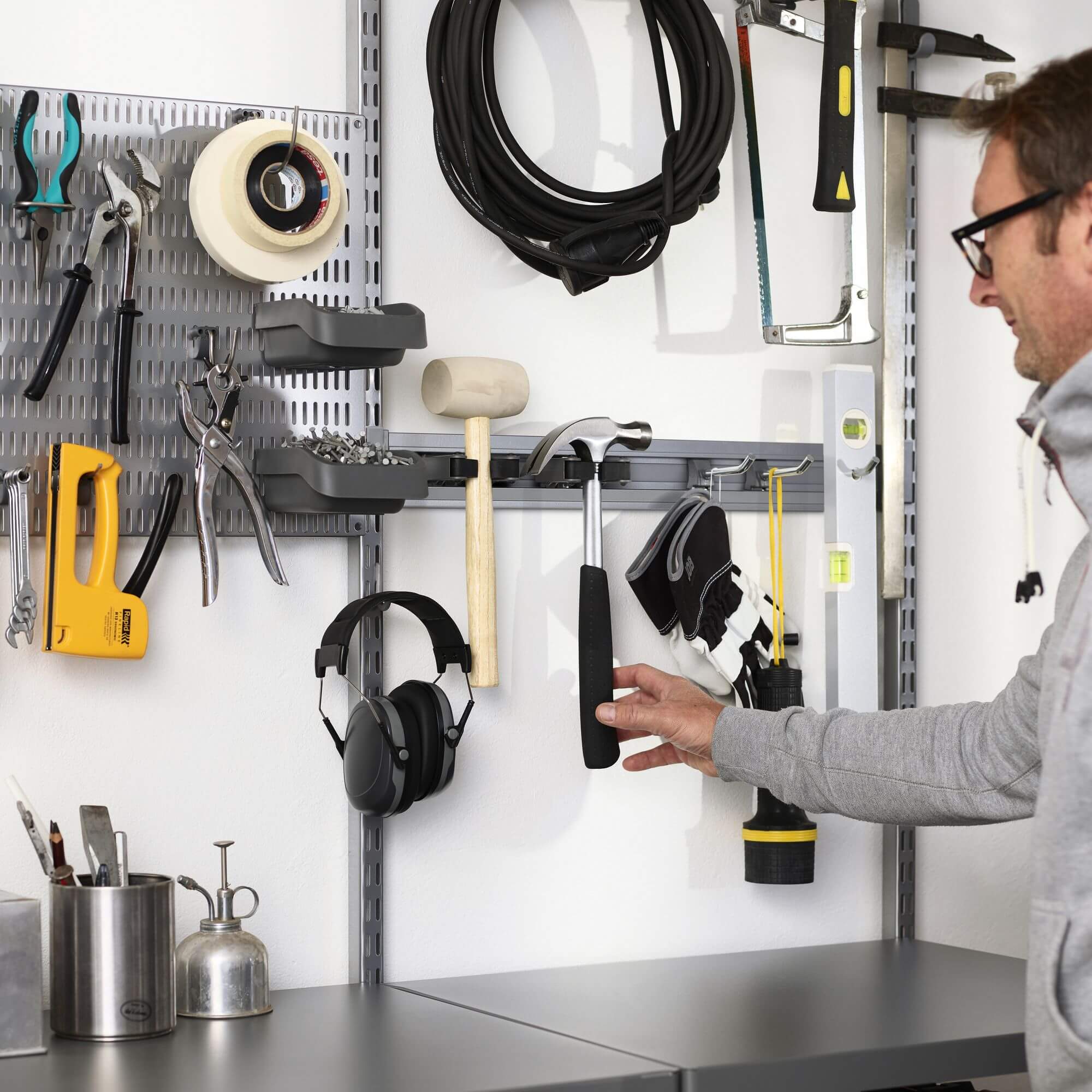 An Elfa Storing Board and Elfa Storage Track used to organise tools in a garage or shed