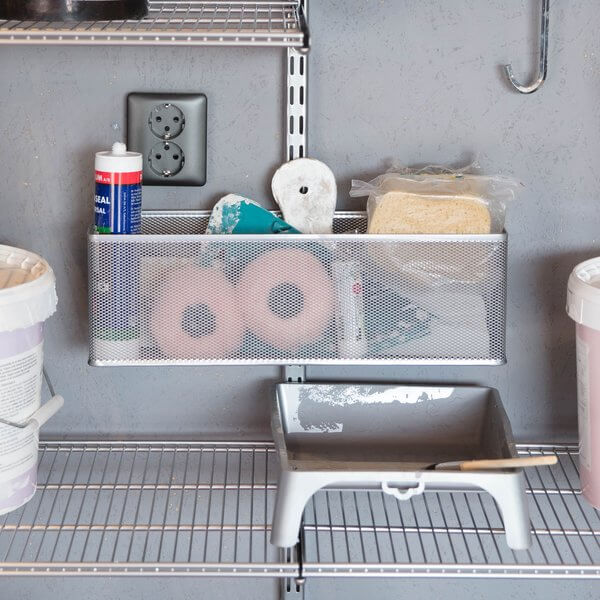 Painting equipment stored inside a Platinum Elfa Mesh Utility Basket