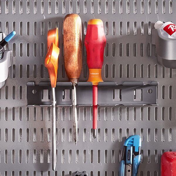 Screwdrivers and other tools stored on a Platinum Elfa Storing Board in a workshop