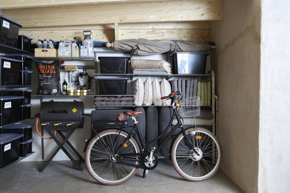 A garage organised with modular Elfa shelving in Platinum