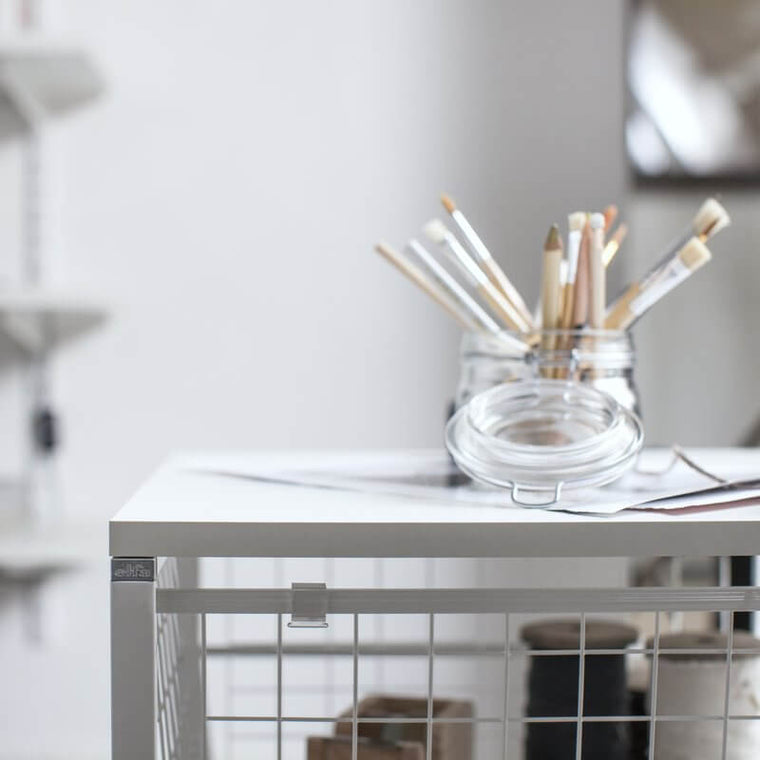 A White Elfa Melamine Top Shelf installed on an Elfa Freestanding Drawer Kit