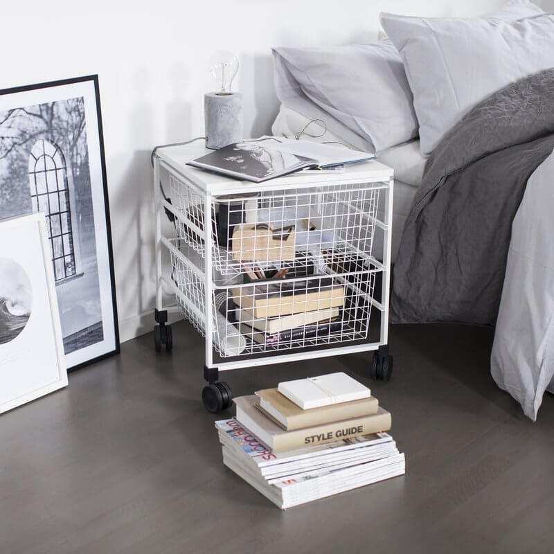 A White Elfa Freestanding Drawer Kit with Wire Drawers installed in a bedroom to organise books